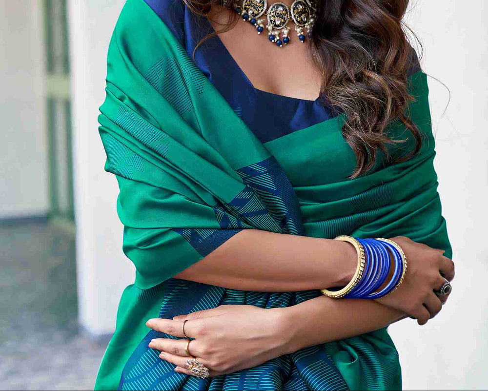 Close-up portrait of model in teal green soft silk saree with oxidised silver choker necklace and blue bangles