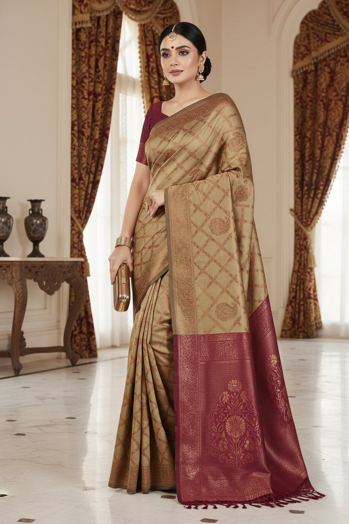 Close-up portrait of model in maroon silk blouse with copper zari floral sleeve border and sweetheart V-neck