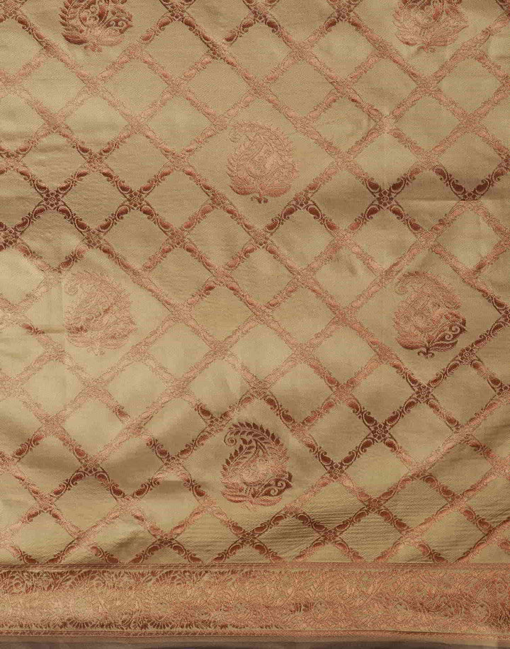 Flat lay close-up of maroon pallu showing large copper zari floral tree buttas and tassel fringe