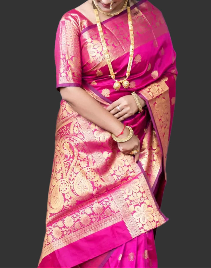 Three-quarter view of model in rani pink Banarasi silk saree showing pallu drape and gold zari border