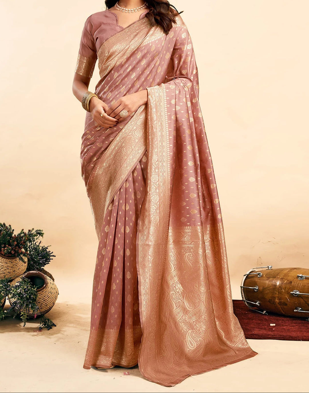 Full front view of model in dusty rose Banarasi silk saree showing all-over antique gold zari paisley buttas and jaal pallu