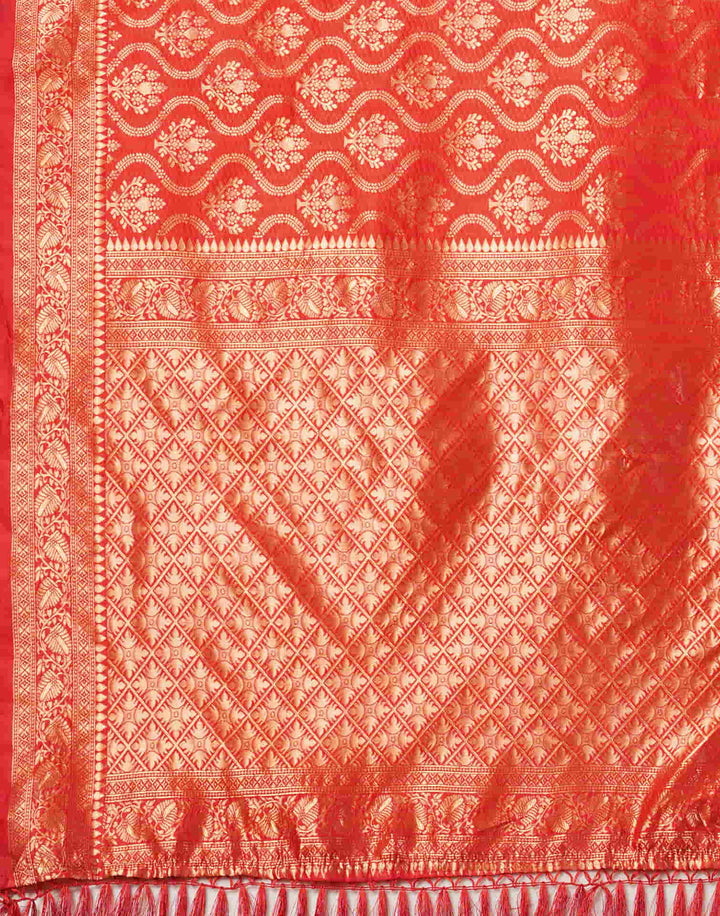 Three-quarter view of model in red Banarasi silk saree with gold jhumkas and bangles