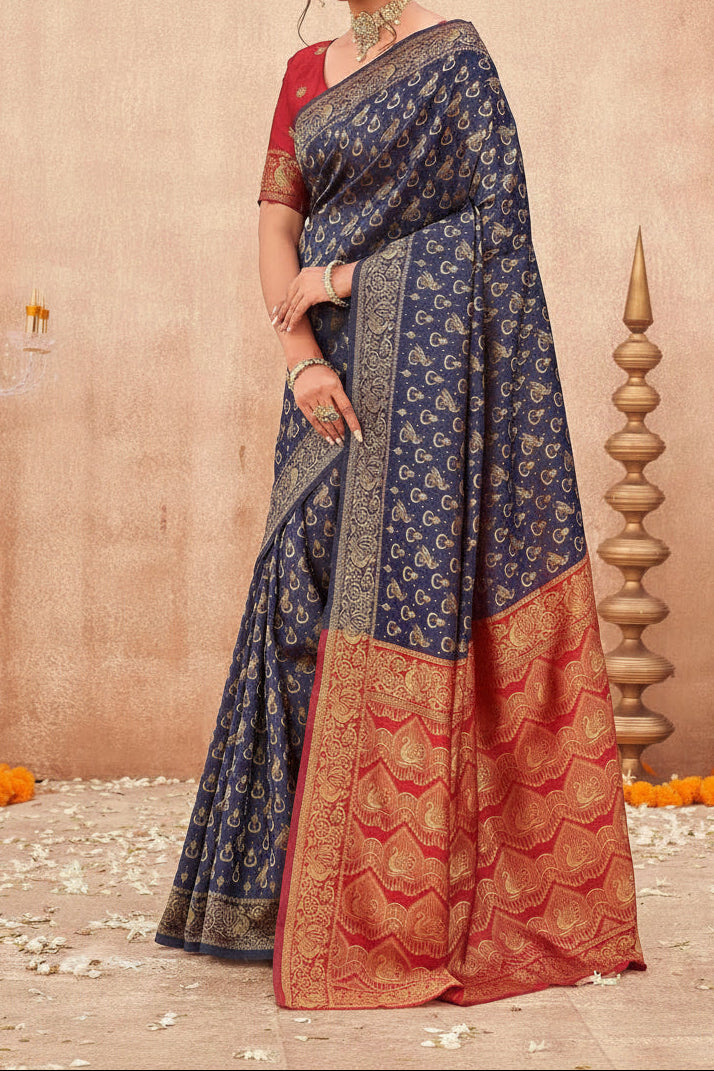 Back view of model in navy blue Banarasi shimmer silk saree showing all-over gold zari paisley buttas and red chevron peacock pallu