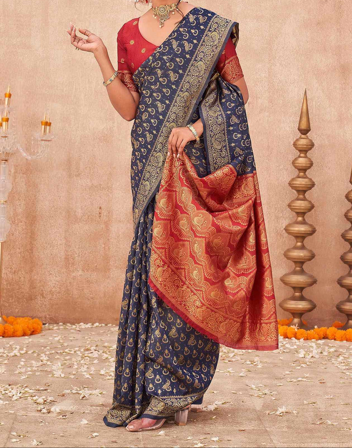 Front portrait of model in navy blue Banarasi shimmer silk saree with red blouse, gold choker necklace and bangles