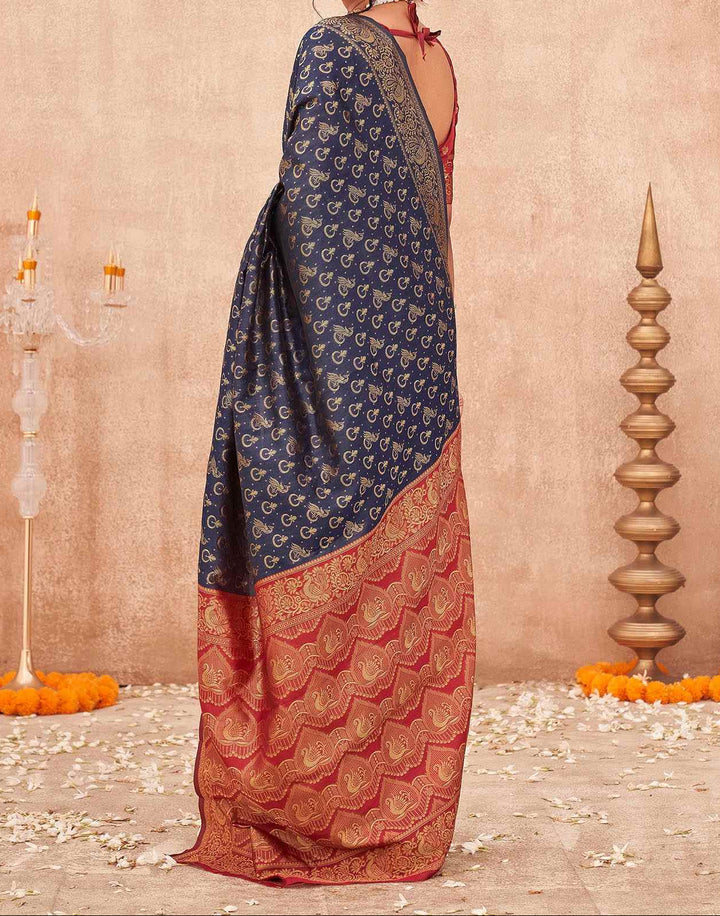 Close-up flat lay of red contrast pallu showing all-over gold zari chevron wave weave with peacock and floral motifs