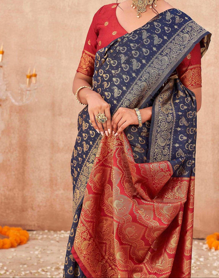 Blouse flat-lay of red silk blouse showing round neck, gold zari lotus butta motifs, and peacock sleeve border design