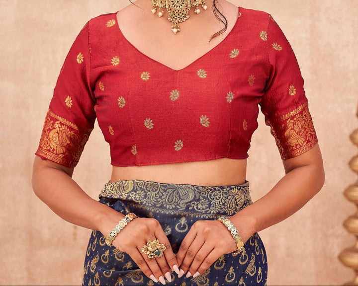 Full front view of model in navy blue Banarasi shimmer silk saree with red blouse and gold jewellery in candlelit setting