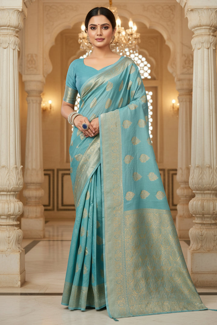 Close-up portrait of model wearing teal blue Banarasi silk saree