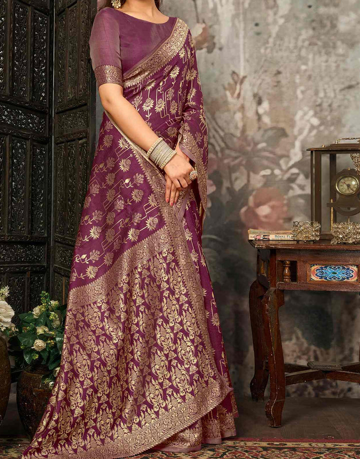 Close-up portrait of model in wine purple Banarasi silk saree showing gold zari sunflower vine buttas and antique gold border