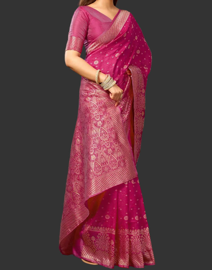 Close-up portrait of model in magenta Banarasi silk saree showing gold zari jaal drape and jewellery