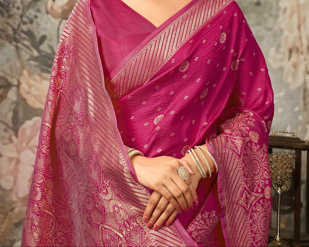 Close-up portrait of model in magenta Banarasi silk blouse with gold zari diagonal stripe sleeve border and V-neck