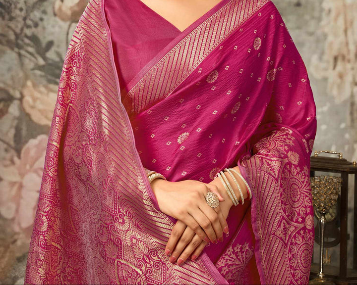Close-up portrait of model in magenta Banarasi silk blouse with gold zari diagonal stripe sleeve border and V-neck