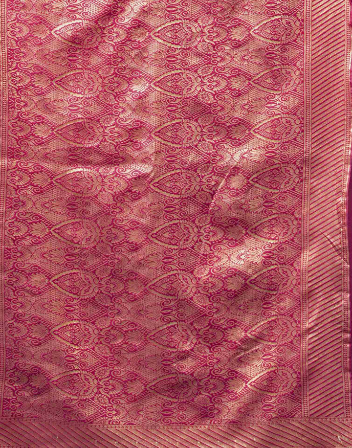 Seated close-up of model in magenta Banarasi silk saree with pearl and gold bangles and ring