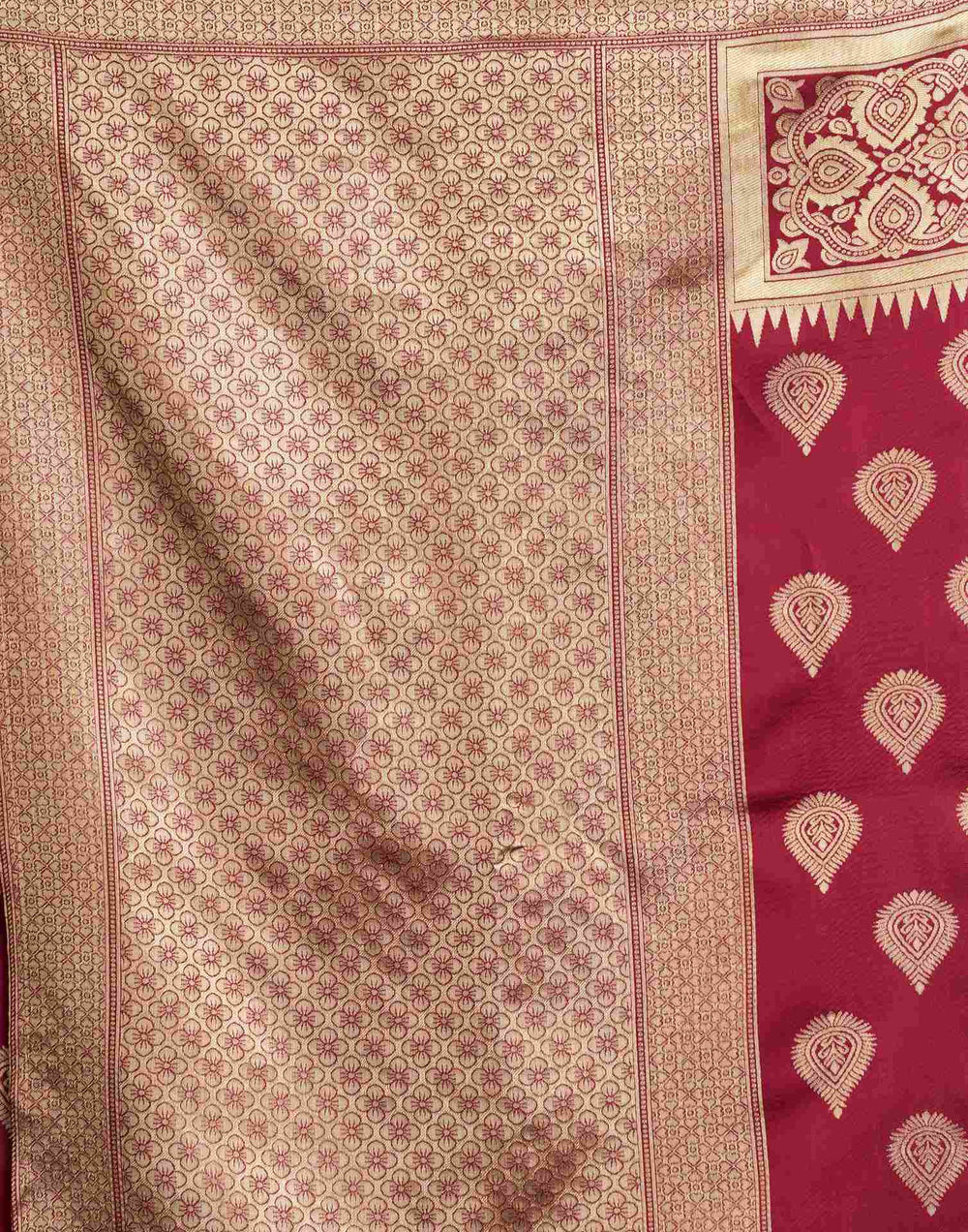 Close-up portrait of model in maroon Banarasi silk saree with square neck blouse, gold polki necklace and bangles