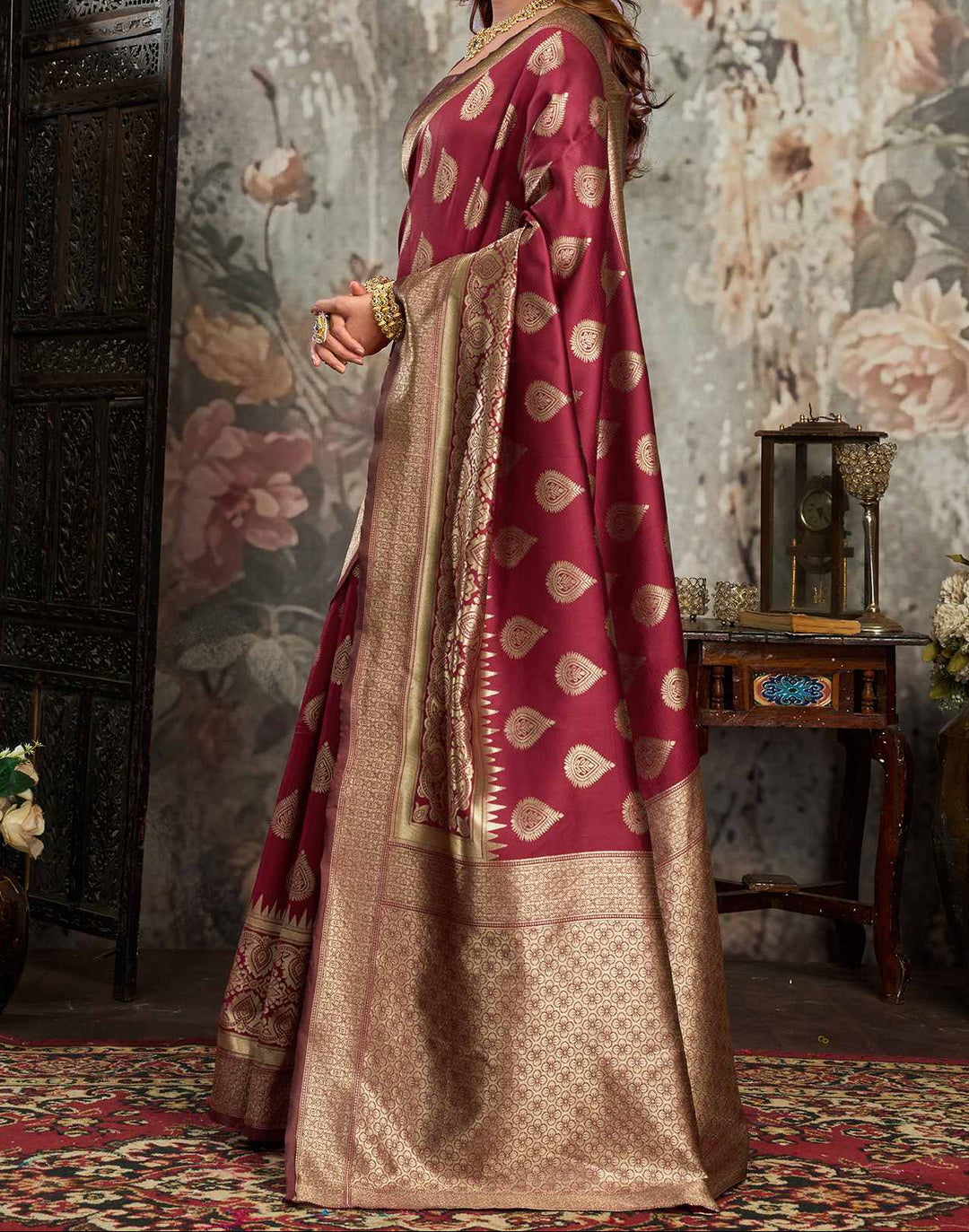 Full front view of model in maroon Banarasi silk saree with large gold zari mango buttas and antique gold border