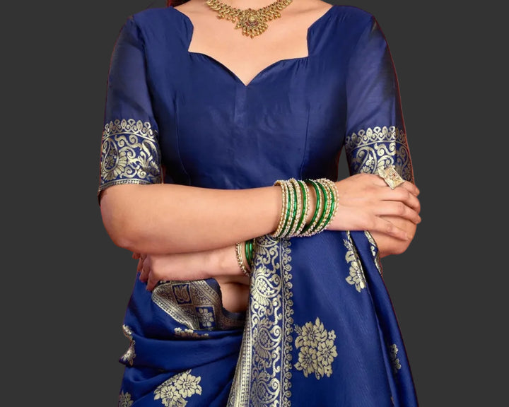 Close-up portrait of model in royal blue Banarasi silk saree with gold zari blouse and temple necklace