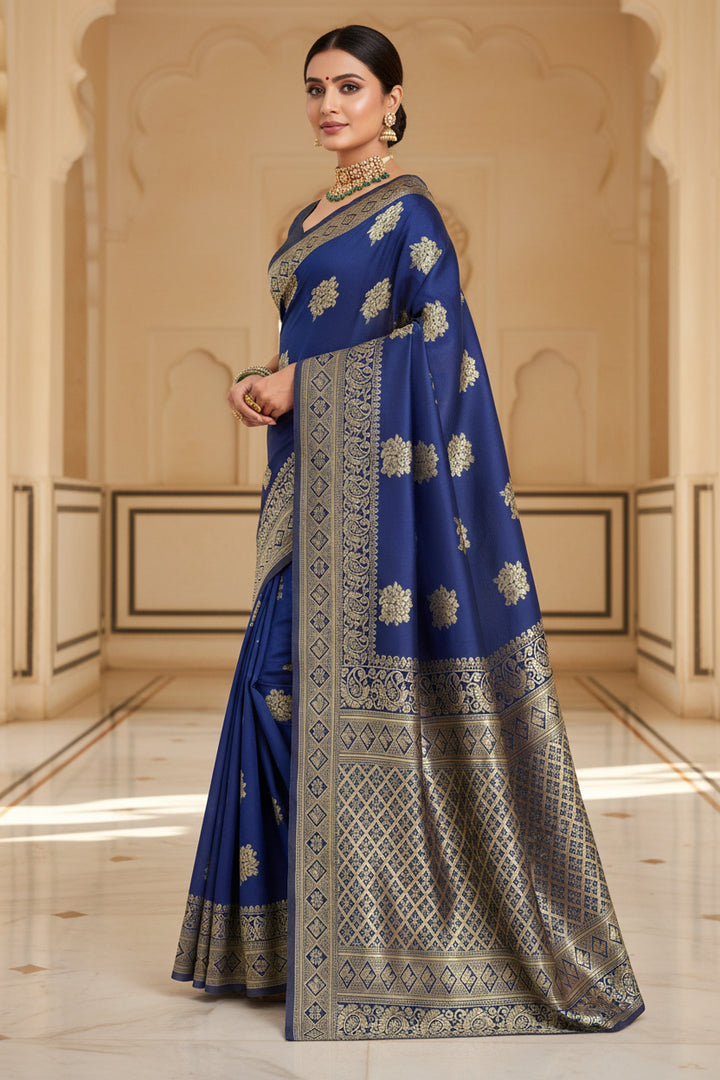 Side profile of model in royal blue Banarasi silk saree showing drape and grand gold zari pallu
