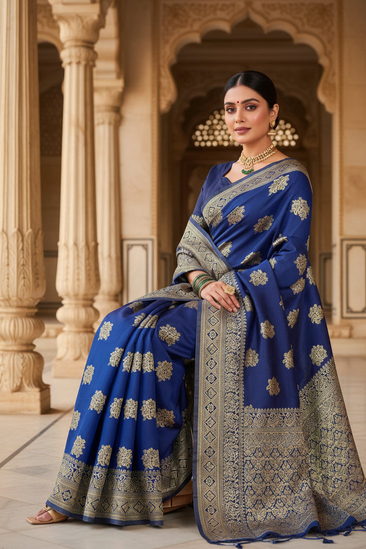 Seated model in royal blue Banarasi silk saree showing scattered gold zari floral buttas