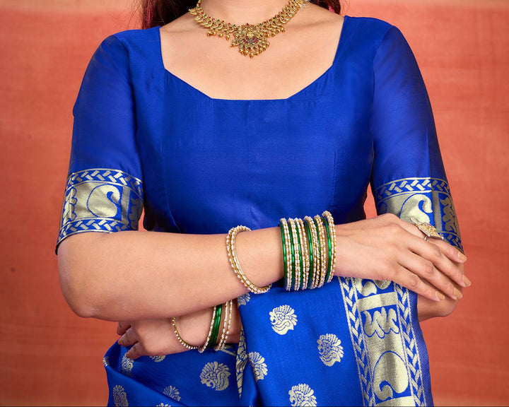 Close-up of royal blue Banarasi silk saree fabric showing all-over gold zari diamond ogee jaal weave