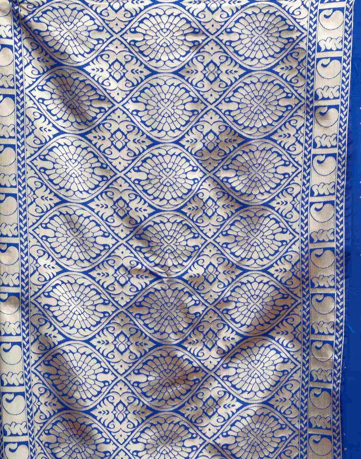 Side portrait of model in royal blue Banarasi silk saree with gold zari shell buttas and gold choker necklace