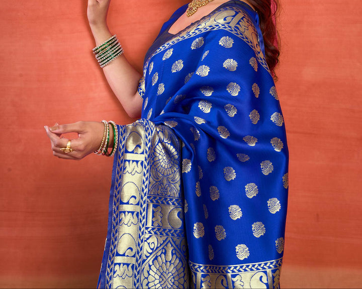 Full front view of model in royal blue Banarasi silk saree showing scattered gold zari shell buttas and grand jaal pallu