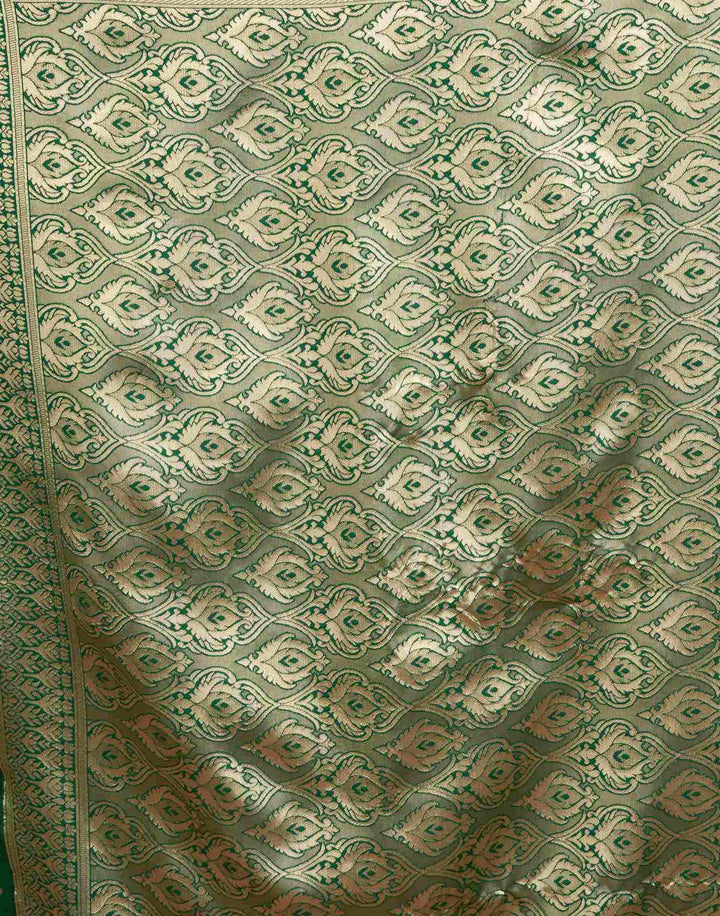 Full front view of model in bottle green Banarasi silk saree with scattered gold zari daisy buttas and antique gold border
