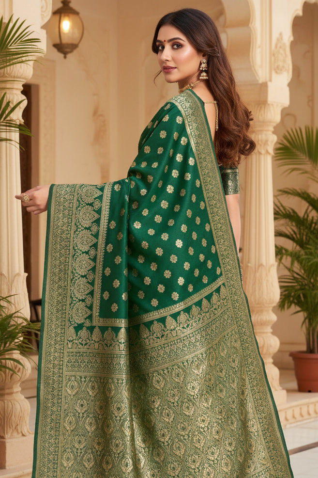 Full front view of model in bottle green Banarasi silk saree with gold zari daisy buttas and antique gold border in terracotta setting