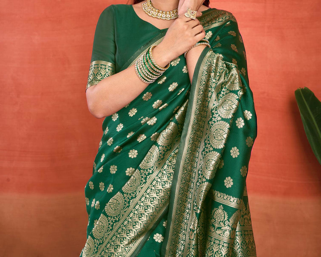 Three-quarter view of model in bottle green Banarasi silk saree showing gold zari daisy buttas and dense diamond jaal pallu drape