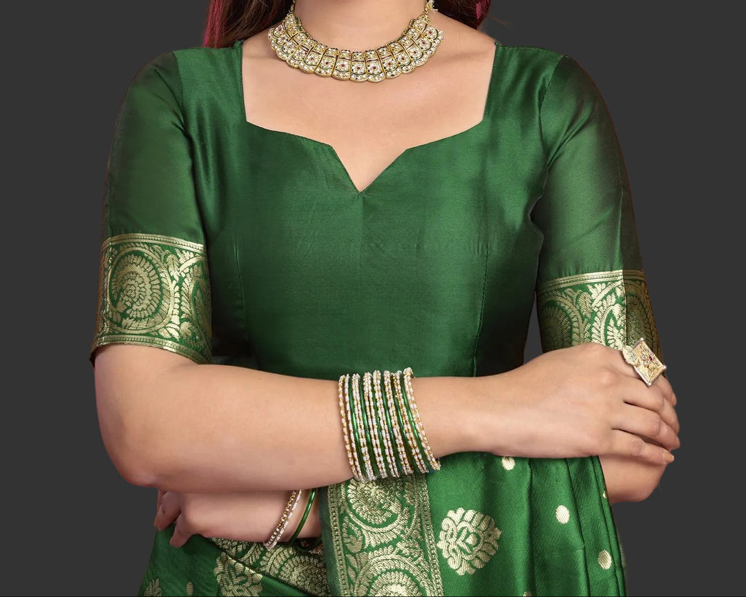 Close-up of bottle green Banarasi silk saree fabric showing gold zari jaal and oval medallion weave