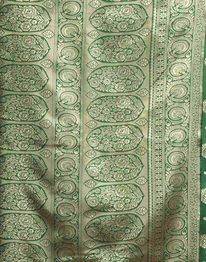 Full front view of model in bottle green Banarasi silk saree with gold zari buttas