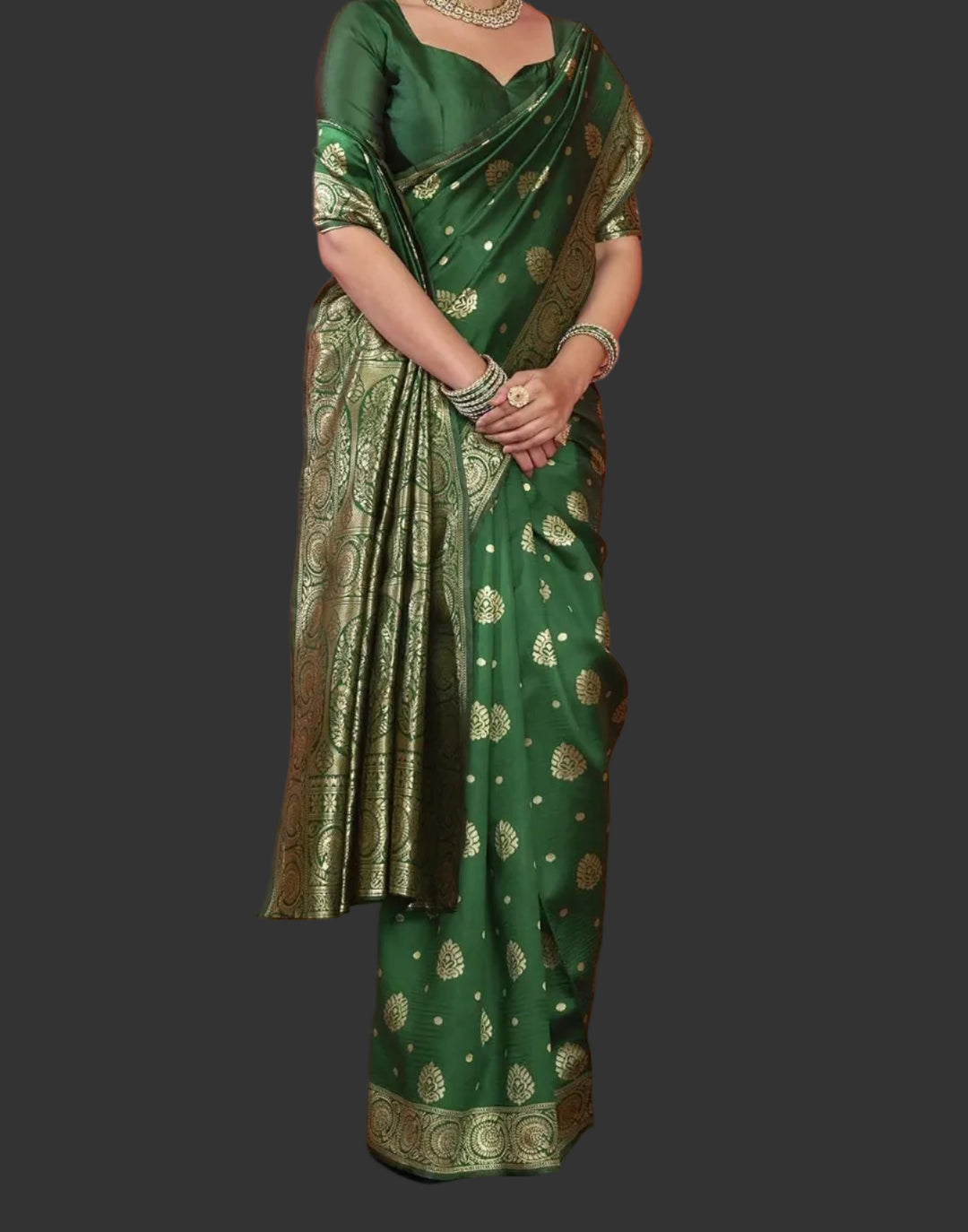 Seated close-up of model in bottle green Banarasi silk saree with polki jewellery
