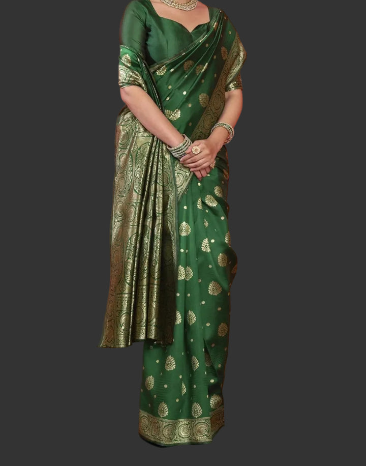 Seated close-up of model in bottle green Banarasi silk saree with polki jewellery