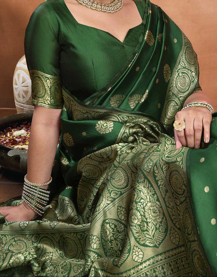 Three-quarter view of model in bottle green Banarasi silk saree with gold zari buttas