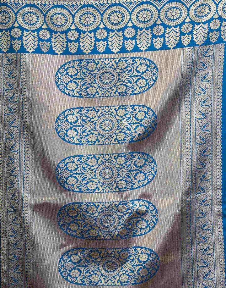 Full front view of model in peacock blue Banarasi silk saree with gold zari buttas and antique gold border
