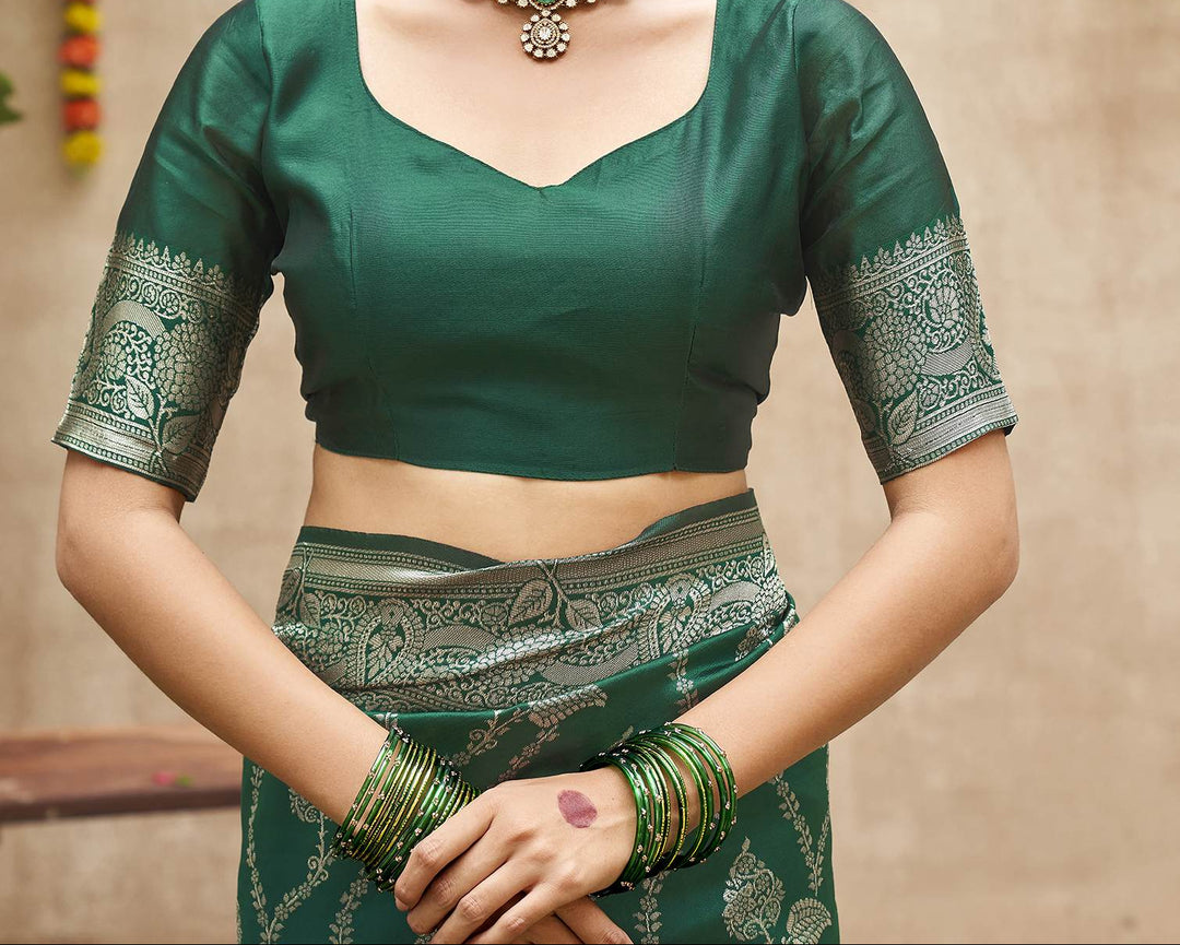 Full front view of model in emerald green Banarasi silk saree with silver zari