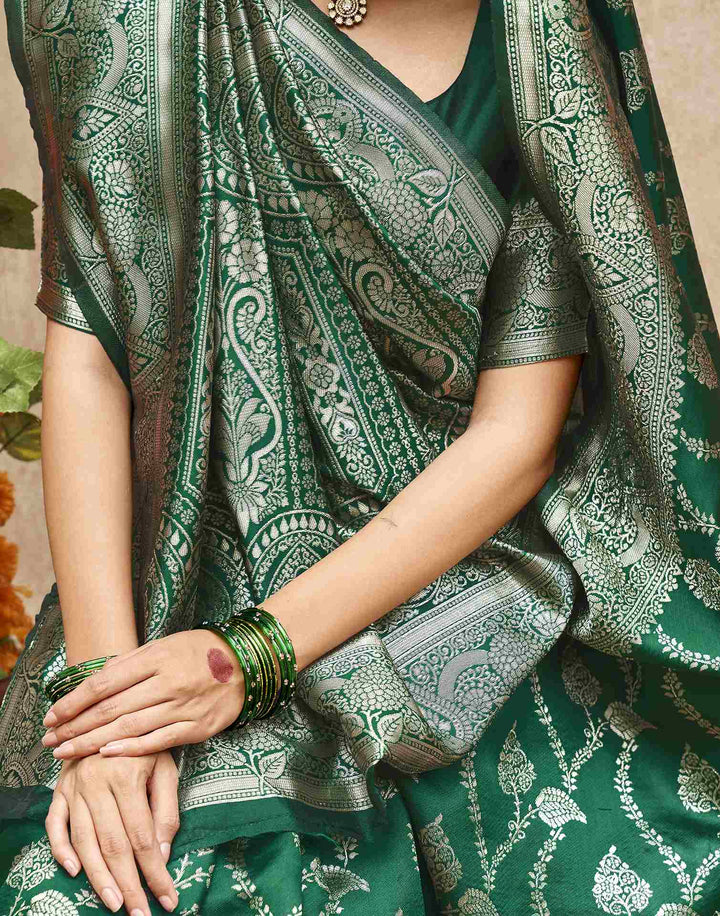 Model wearing emerald green Banarasi silk saree in festive outdoor setting