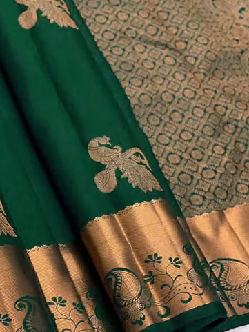 Emerald green Kanjipuram silk saree folded showing body and gold zari pallu