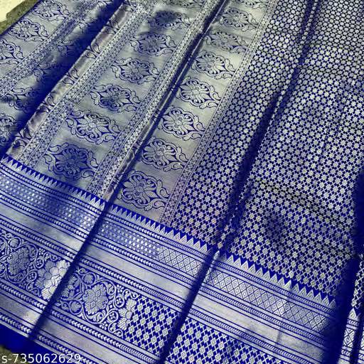 Flat lay close-up of navy blue Banarasi silk saree showing all-over silver zari diamond lattice jaal and multi-row temple border