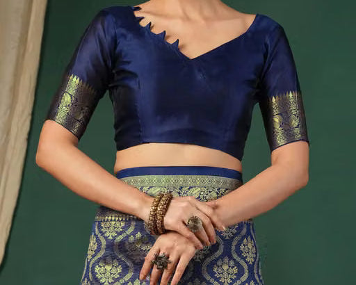 Close-up of royal blue silk blouse with V-neckline and gold zari sleeve border