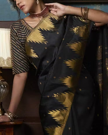 Black Kanjipuram Silk Saree - Model holding pallu showing gold zari temple border