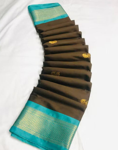 Model wearing brown Kanjipuram silk saree with teal border and gold zari work