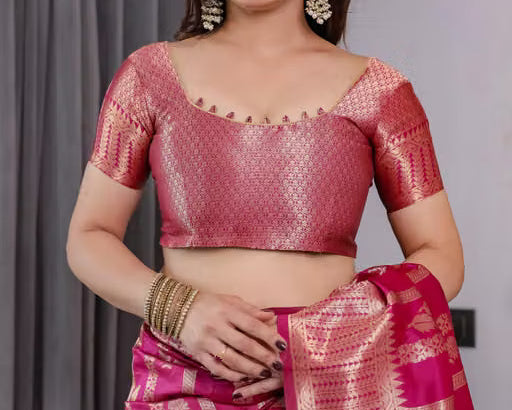 Model wearing pink Banarasi silk saree with gold zari - smiling front view